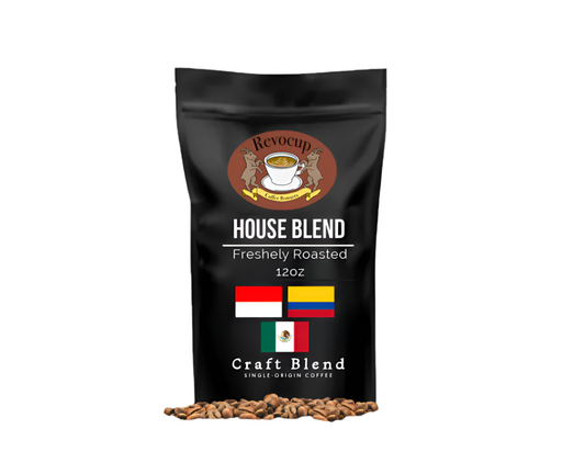 A bag of Revocup Coffee House Blend featuring a black design with coffee beans in front and the product name 'House Blend Freshly Roasted 12oz'. The bag indicates it's a craft blend.