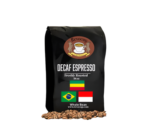 A black bag of Revocup Decaf Espresso Whole Bean coffee, 24 oz, stands upright on a pile of roasted coffee beans.