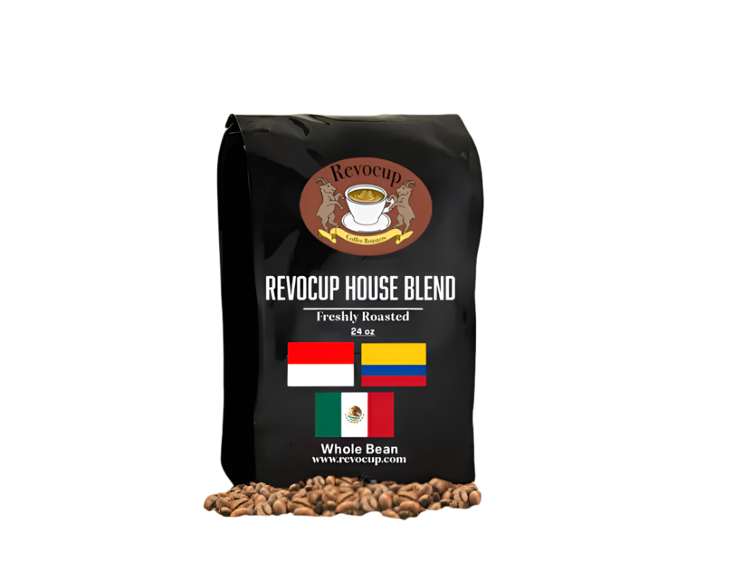 A black bag of Revocup House Blend Whole Bean coffee, 24 oz, stands upright on a pile of roasted coffee beans.