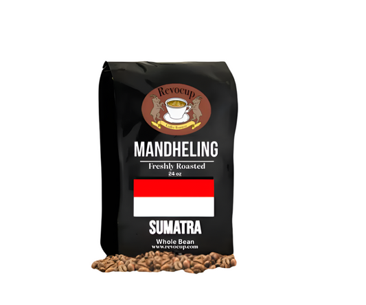 A black bag of Revocup Mandheling Sumatra Whole Bean coffee, 24 oz, stands upright on a pile of roasted coffee beans.