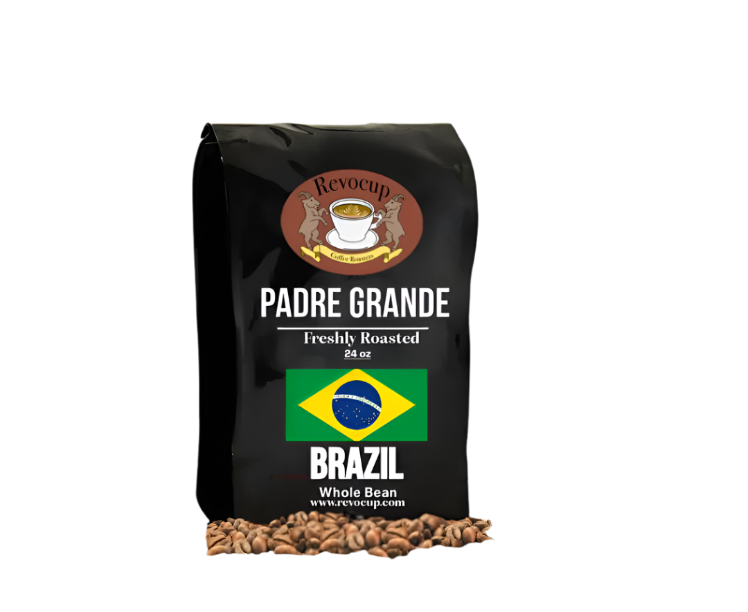 A black bag of Revocup Padre Grande Brazil Whole Bean coffee, 24 oz, stands upright on a pile of roasted coffee beans.